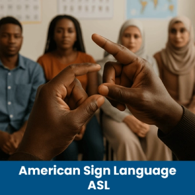 A group of people seated in a room, with a man hands Interpreting in ASL.